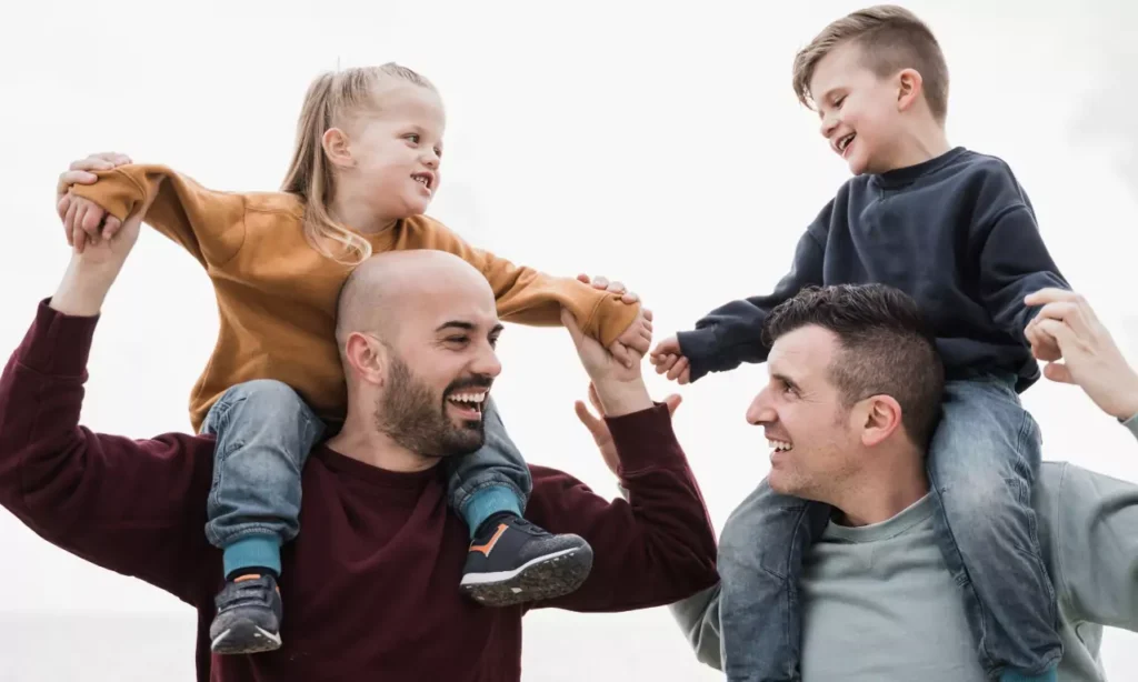 young gay father and sons having fun together on t