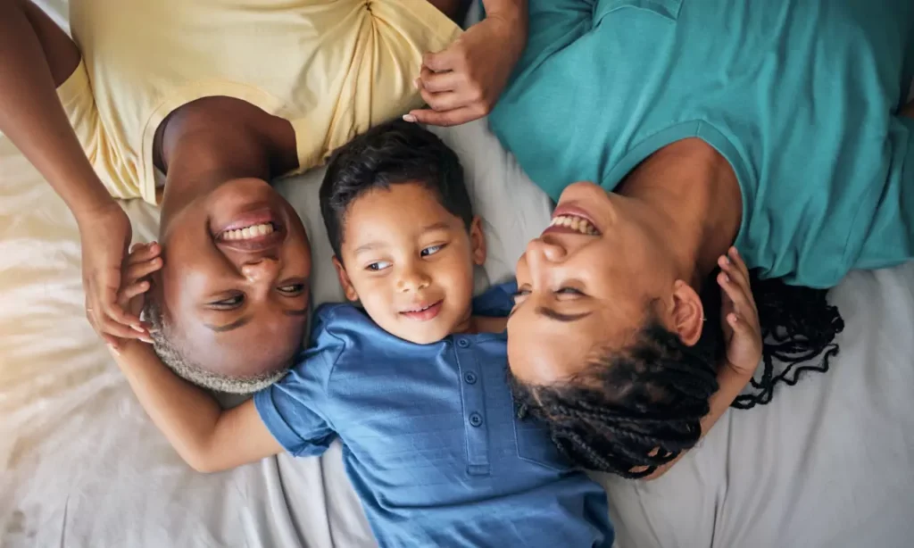 child lgbt family and happy on bed in home bedroo